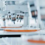 Cellular Droplets: The Secret to Fighting ALS Automated laboratory equipment with robotic arms dispensing liquids into petri dishes