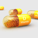 Unseen Aging: Vitamin D’s Role Exposed Vitamin D capsules with orange beads inside