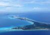 Aerial view of a tropical island surrounded by blue ocean waters