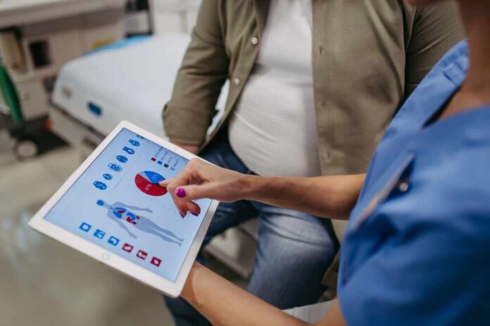 Nurse showing a patient health data on a tablet