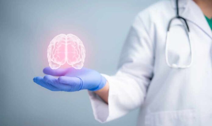 A medical professional holding a glowing digital brain illustration in their hand