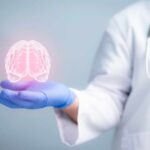 Brain Hack Slashes Dementia Risk by 25% A medical professional holding a glowing digital brain illustration in their hand