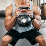 Squat-Cardio Debate: Are You Wrong? Athlete performing a kettlebell squat in a gym