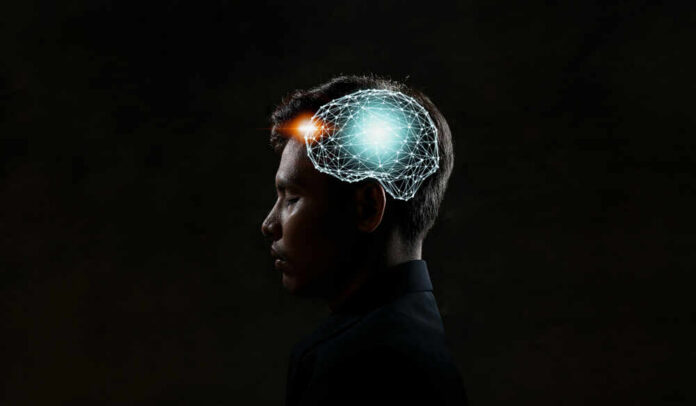shutterstock_1121158859.jpg Profile of a person with a digital brain overlay illustrating neural connections