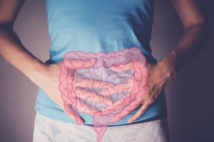 Person holding their stomach with a graphic of intestines overlayed