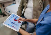 Nurse showing a patient health data on a tablet