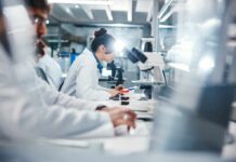 Ant2 Blockade: The Intriguing Cancer Breakthrough Scientists working in a laboratory with microscopes and test tubes