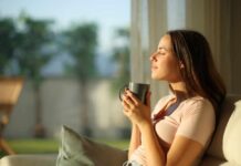 Massive Study Flips Coffee Anxiety Myth Woman enjoying a cup of coffee in a sunlit room