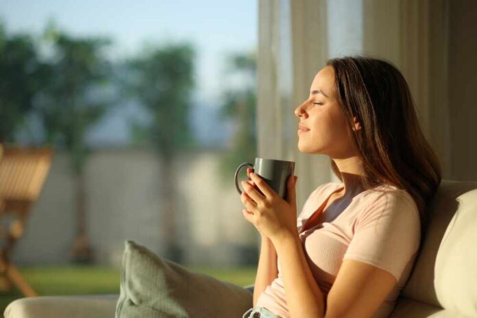 Woman enjoying a cup of coffee in a sunlit room
