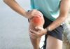 Boswellia Serrata: The New Knee Pain King? Athlete holding their knee in pain while exercising outdoors
