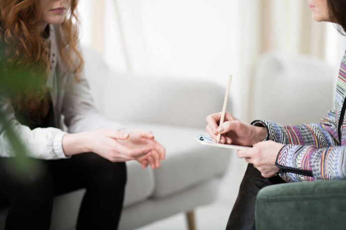 shutterstock1096053290jpg Two individuals engaged in a counseling session, one taking notes