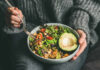 Diet That Blocks Brain Decline A person holding a bowl of colorful salad with avocado and greens