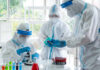 Scientists in protective suits conducting research in a laboratory