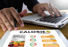 The DIET UPGRADE That BEATS Diabetes! Person using a calorie counter app on a tablet while working on a laptop