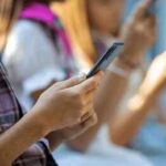 Hands of young people using smartphones