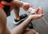 Person pouring probiotic pills into their hand