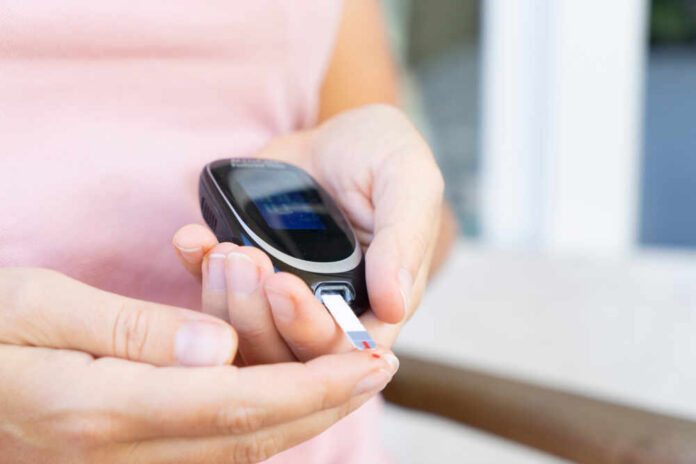 Person using a blood glucose meter to check their levels