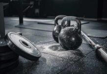Over-40 Muscle Myth SHATTERED Kettlebells and weights on a gym floor with chalk dust