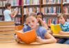 Children reading books in a library