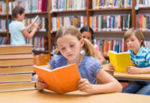 Children reading books in a library