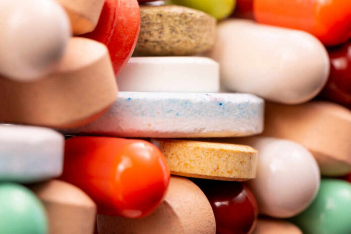 Different,Colorful,Pills,And,Capsules,Stacked.,Global,Pharmaceutical,Industry,For A close-up view of a variety of colorful pills and tablets stacked together