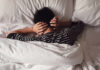 Silent Insomnia Gender Divide Stuns Sleep Scientists Child lying in bed with hands over ears