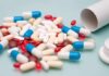 Pills That Steal Hearing Assorted pills and capsules spilled from a bottle