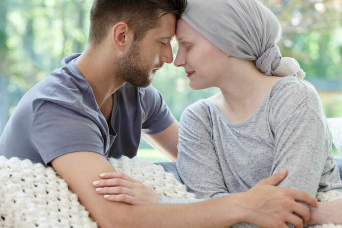 A couple sharing a tender moment, foreheads touching, in a cozy setting