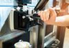 soft serve machine dispensing ice cream into a paper cup