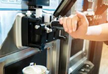 soft serve machine dispensing ice cream into a paper cup