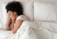 Woman sleeping on white bedding