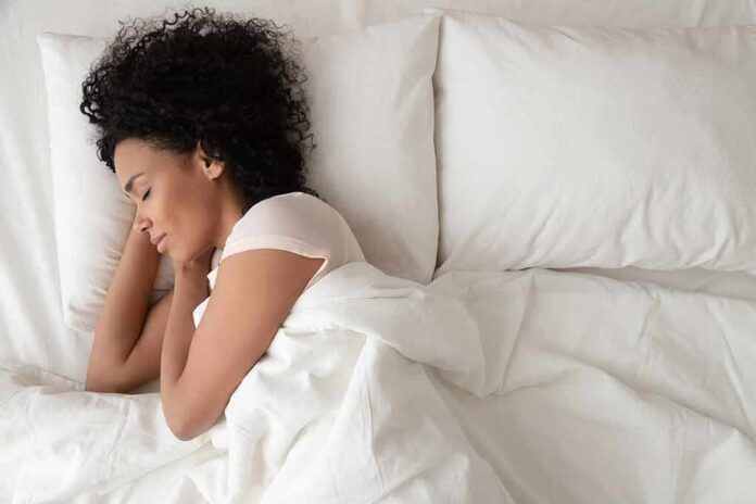 Woman sleeping on white bedding