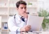 England’s Cancer Vanishing Act Stuns Researchers Doctor reviewing a file at a desk
