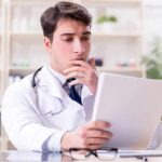 Doctor reviewing a file at a desk