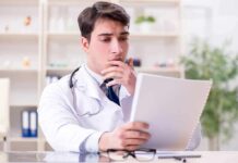 Doctor reviewing a file at a desk