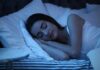 Woman sleeping on her side in bed