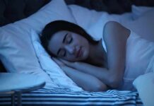 Woman sleeping on her side in bed