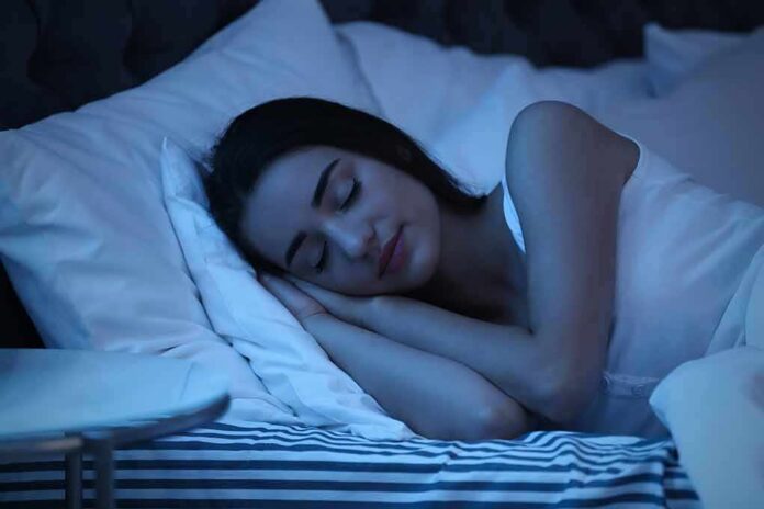 Woman sleeping on her side in bed