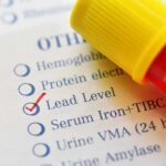 Blood sample tube on lab test form with lead level checked