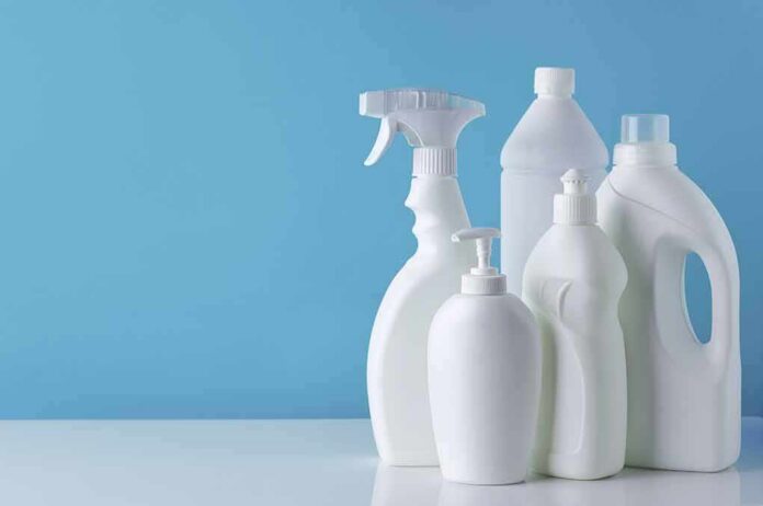 shutterstock_1723883560 White plastic cleaning bottles against a blue background
