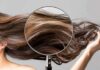 Magnifying glass highlighting long brown hair