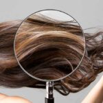 Magnifying glass highlighting long brown hair