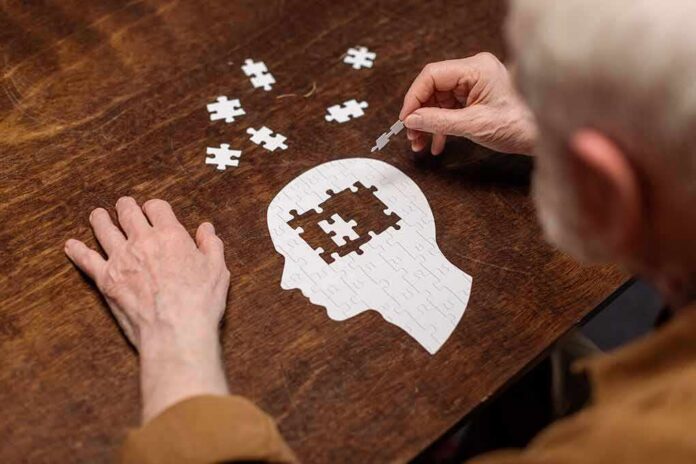 Hands assembling a head-shaped jigsaw puzzle on a wooden table