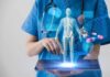 Healthcare professional uses tablet with medical holograms