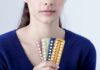 Woman holding blister packs of pills