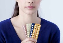 Woman holding blister packs of pills
