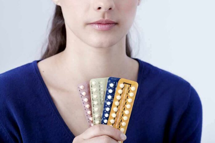 Woman holding blister packs of pills