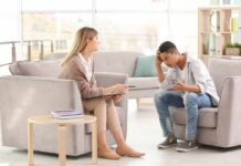 Trauma: Understanding and Navigating Emotional Triggers Teen talking with therapist in a bright office