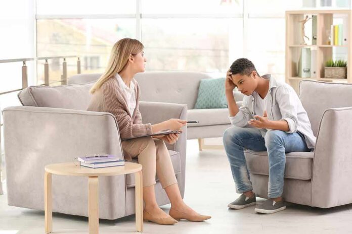 Teen talking with therapist in a bright office