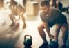 Man lifting kettlebell in gym